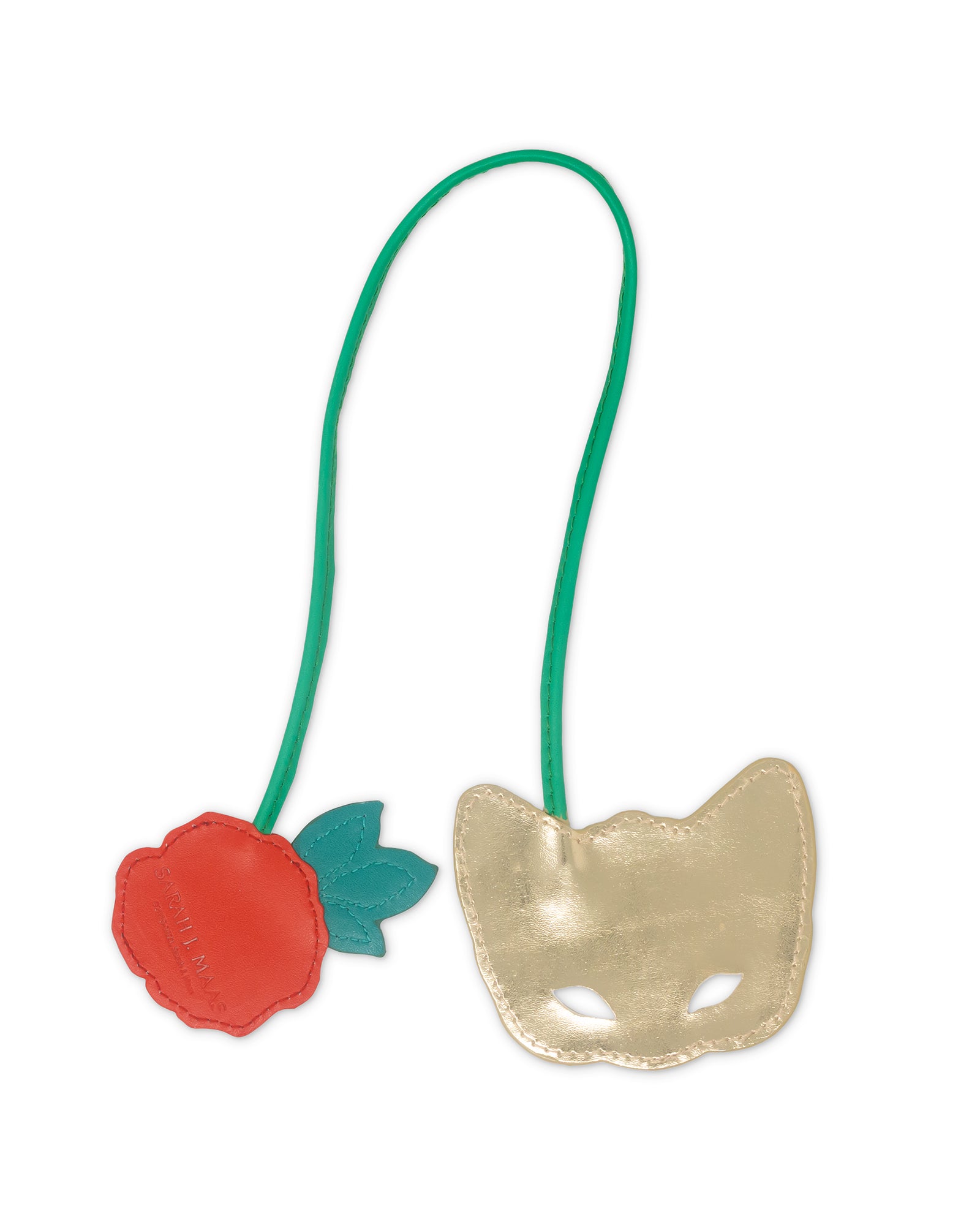 back view of gold mask with green strap and red rose on a white background