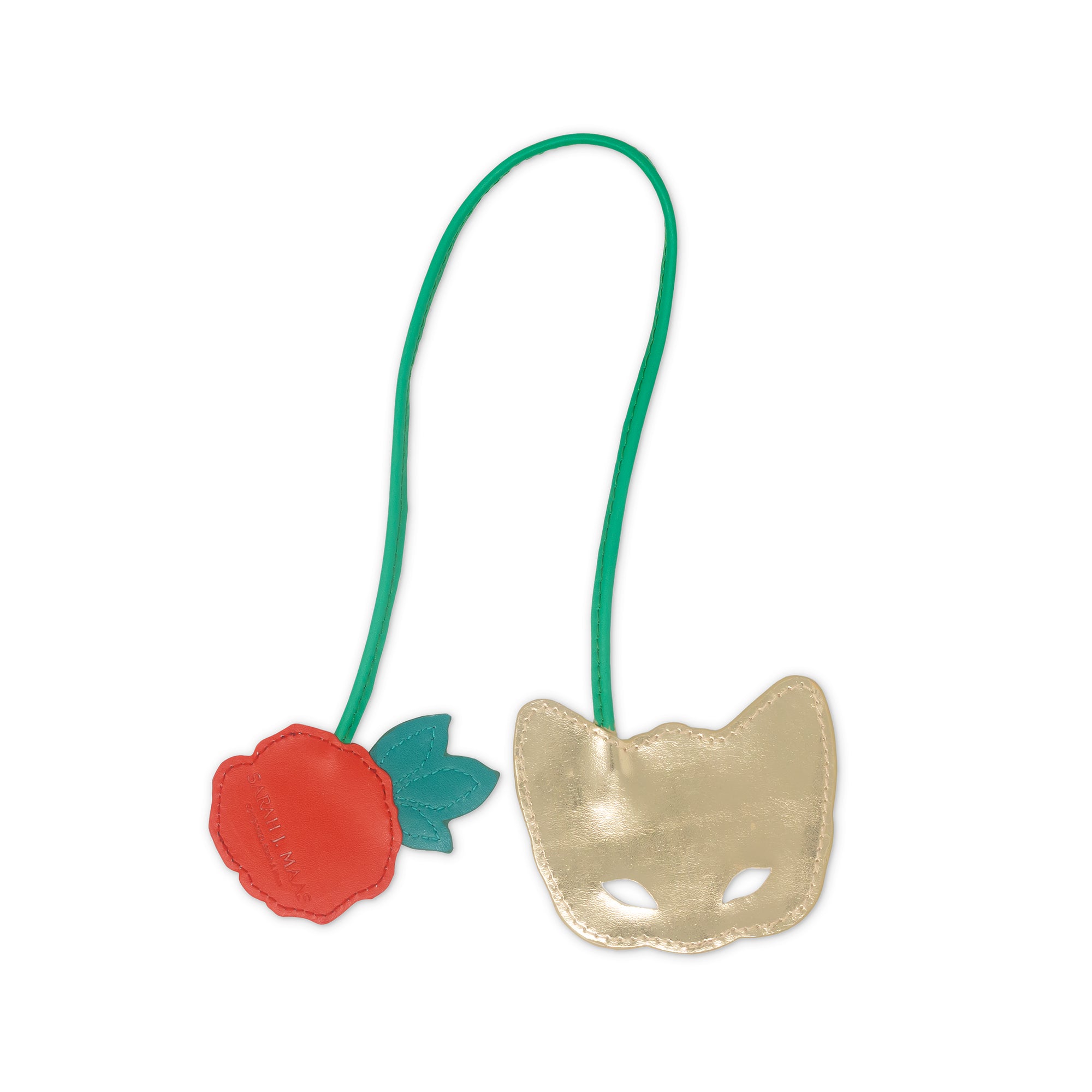 back view of gold mask with green strap and red rose on a white background