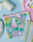 Colorful pouch with floral design on a blue background