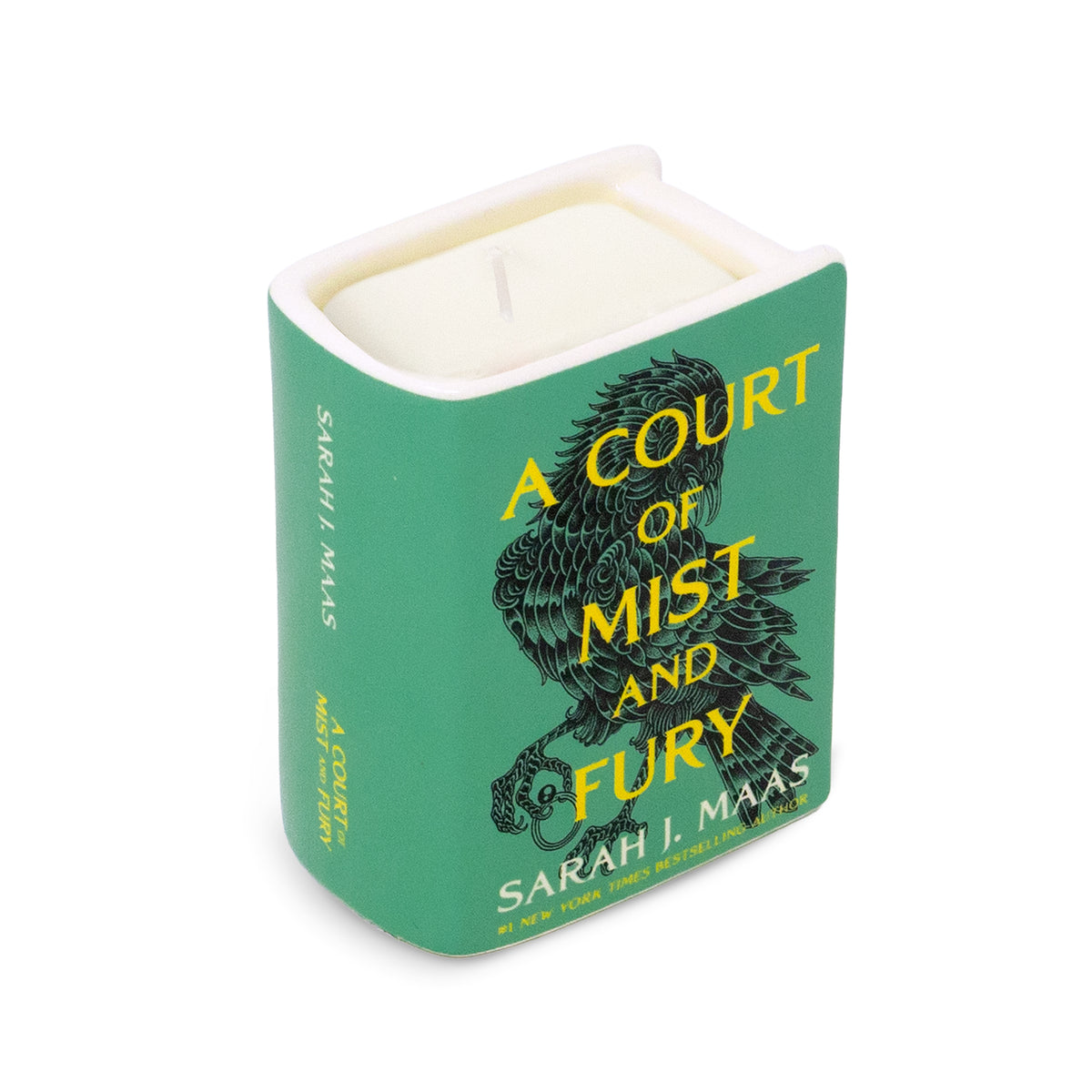 A square candle with a green cover featuring the title 'A Court of Mist and Fury' and the author name Sarah J. Maas, with a black bird illustration and cream-colored wax visible inside.