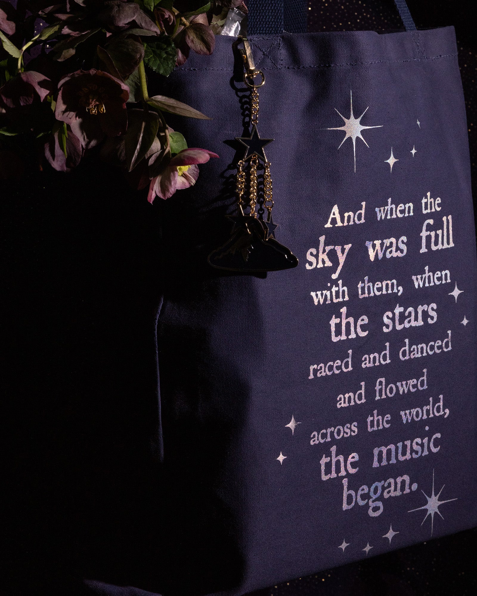 side view of Navy tote bag with white text and star graphics