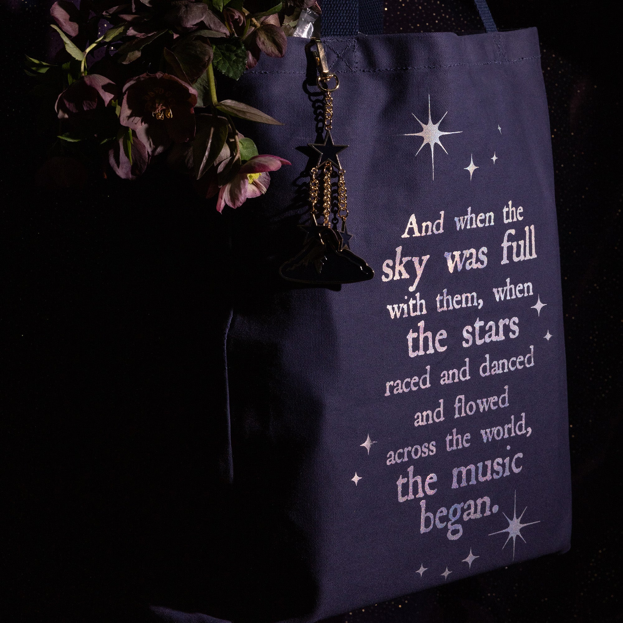 side view of Navy tote bag with white text and star graphics