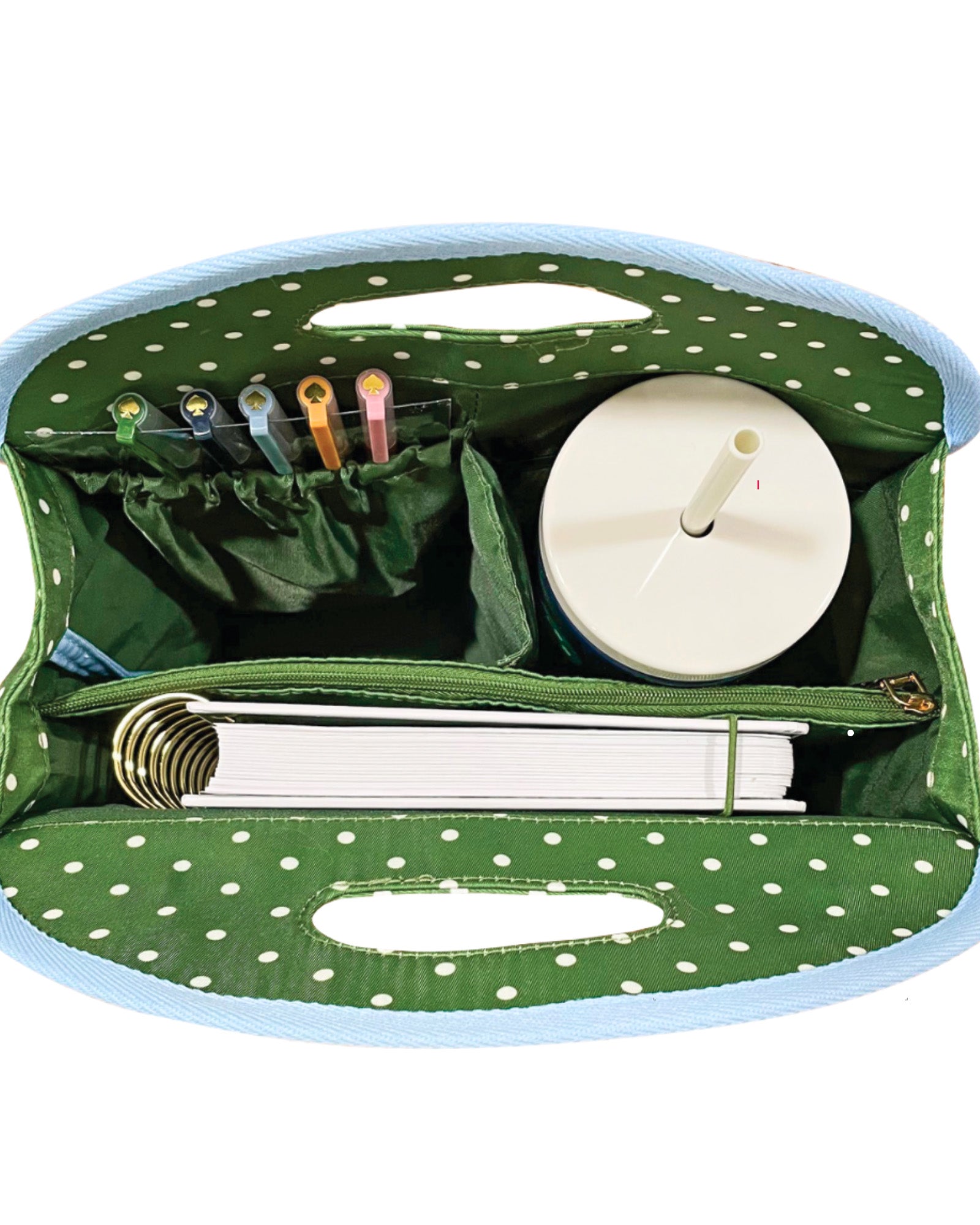interior of Green polka dot bag with blue trim on a white background