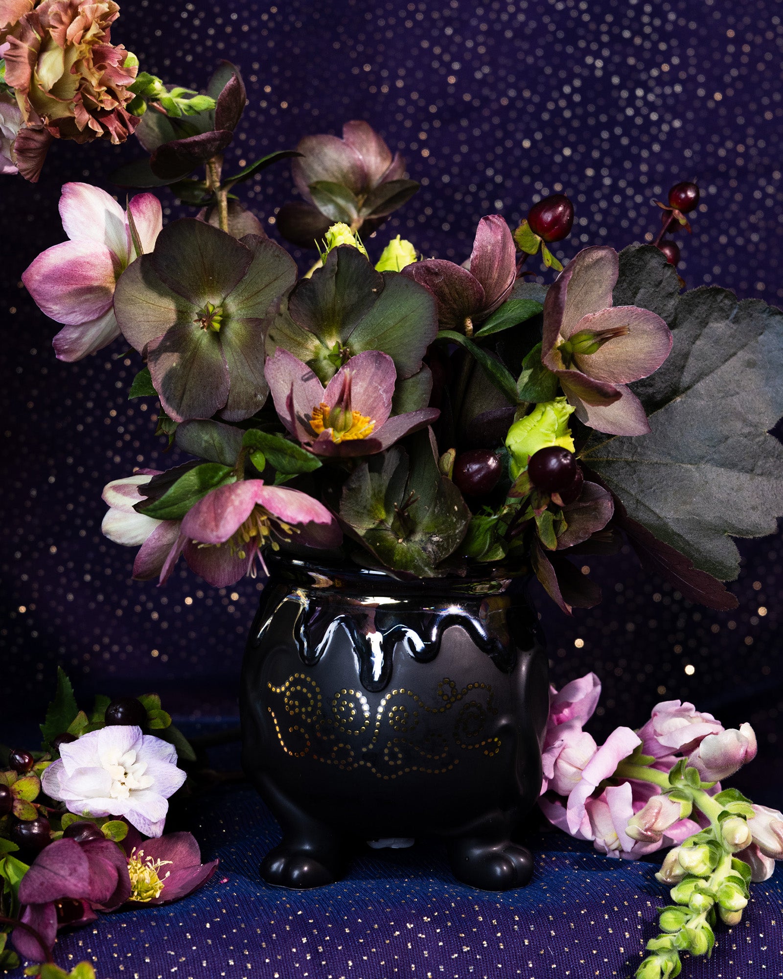 Black decorative pot with flowers inside