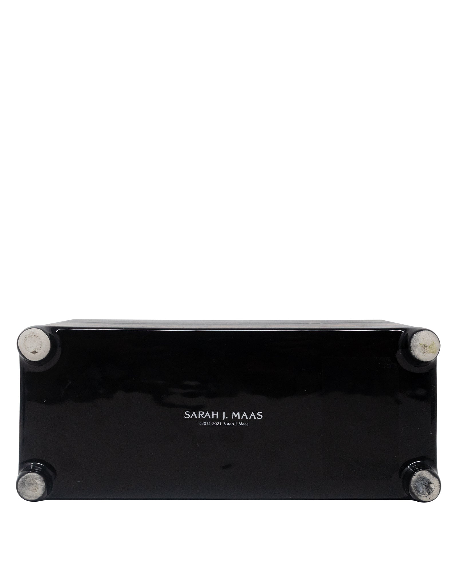 bottom view of black planter with floral and fiery designs on a white background