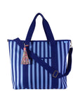 Dark blue and light blue striped tote bag with a tassel on a white background