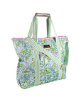 Floral patterned tote bag with green straps on a white background