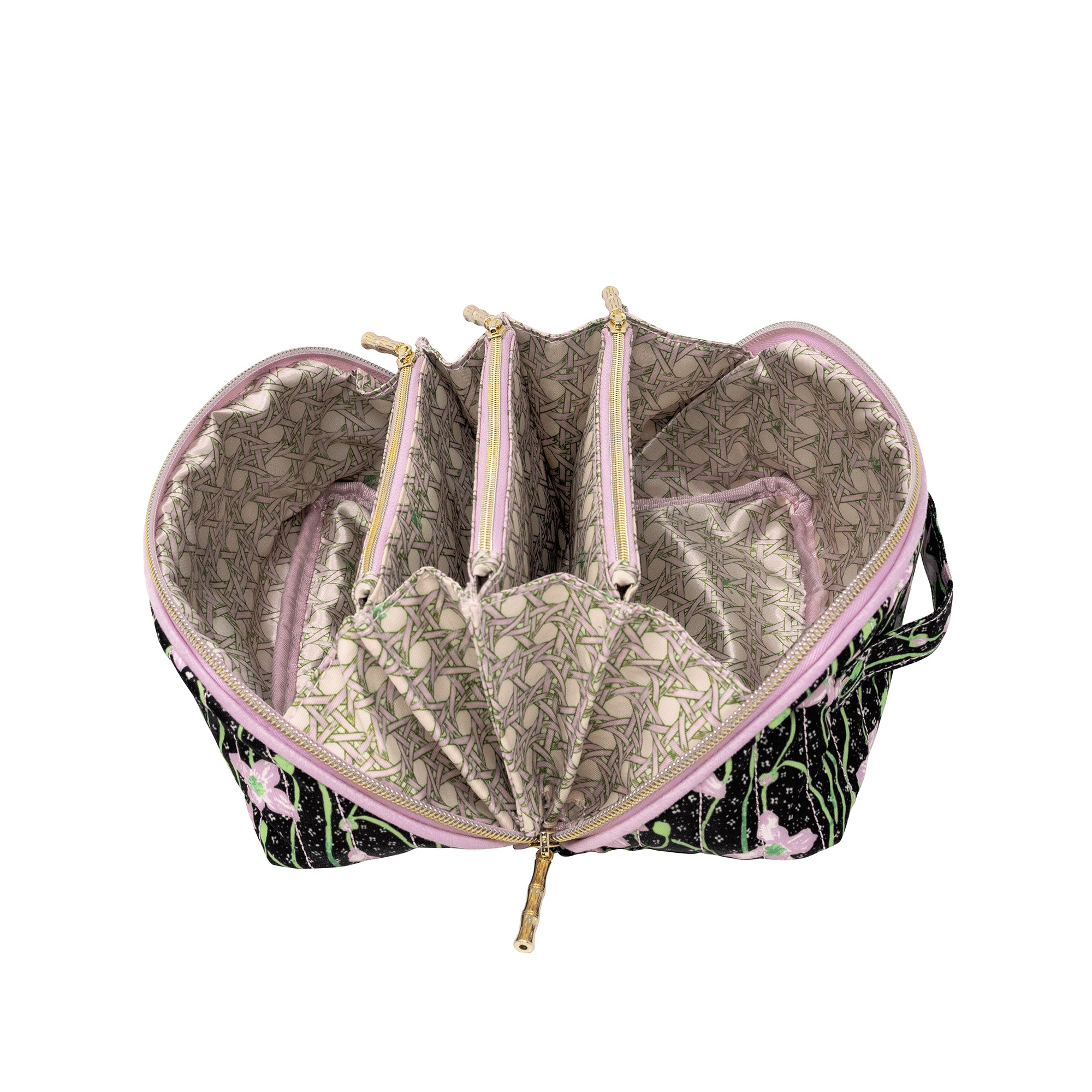 An open makeup bag with a black and pink floral exterior, a light beige patterned interior lining, and multiple zippered compartments, shown on a white background.