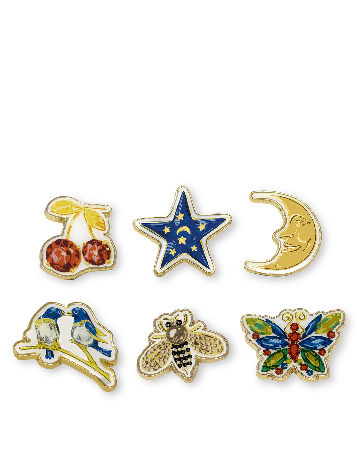 Six small enamel pin designs arranged on a white background: cherries, a blue star with gold stars and a crescent moon, a smiling crescent moon, two blue birds, a bee, and a colorful butterfly.