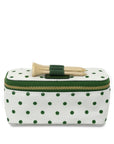 Polka dot makeup bag with hair clips on a white background