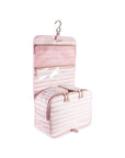 Pink striped toiletry bag with hanging hook on a white background