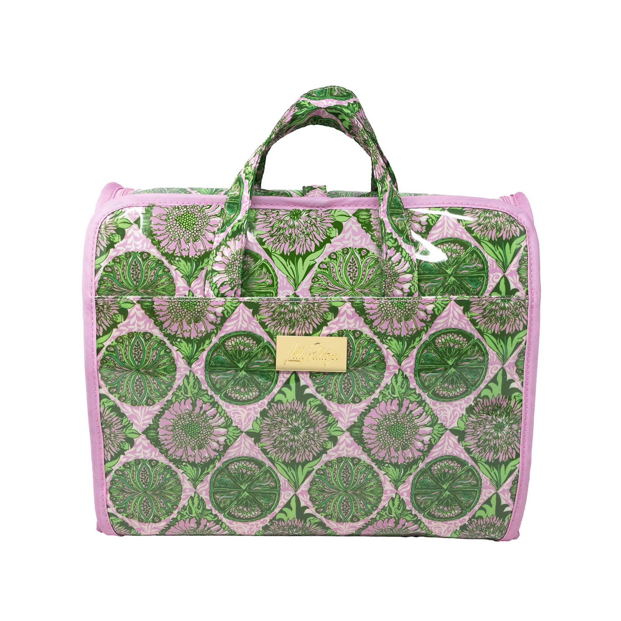A rectangular duffel or carry-on bag with a pink and green floral medallion pattern, featuring dual top handles, a front pocket, and a small gold-tone metal plaque on the front.