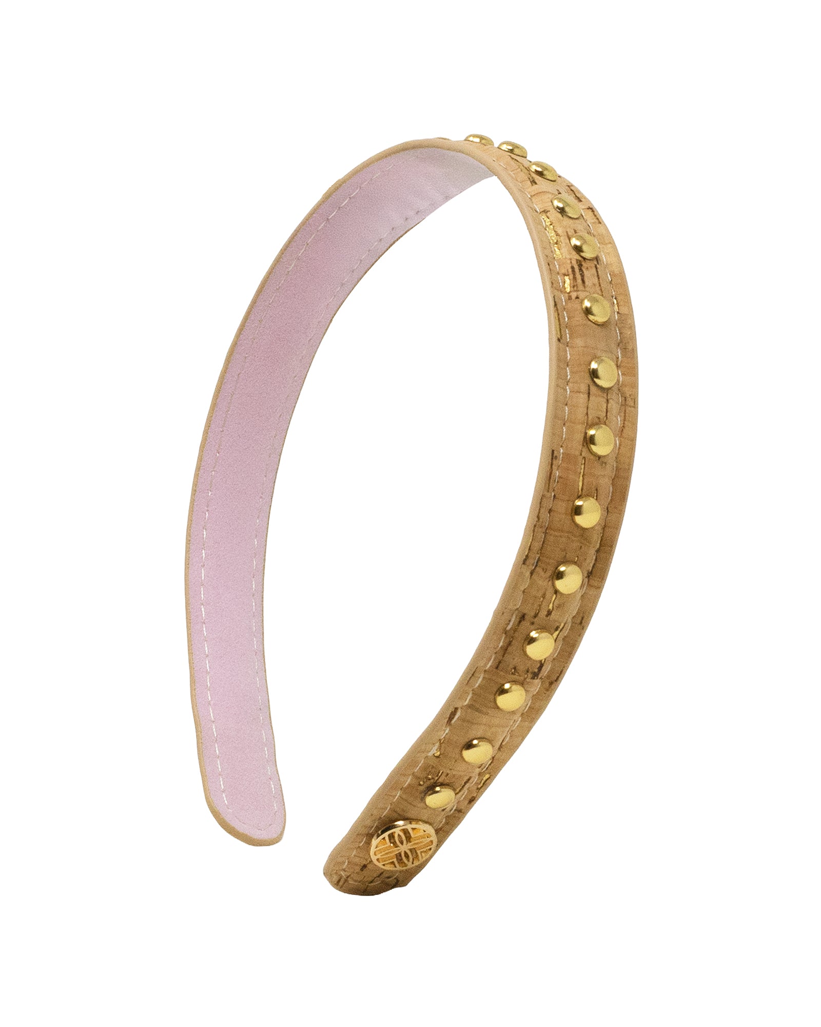 A curved tan leather headband decorated with gold-tone studs and a small gold medallion, featuring a light pink interior lining, shown on a plain white background.