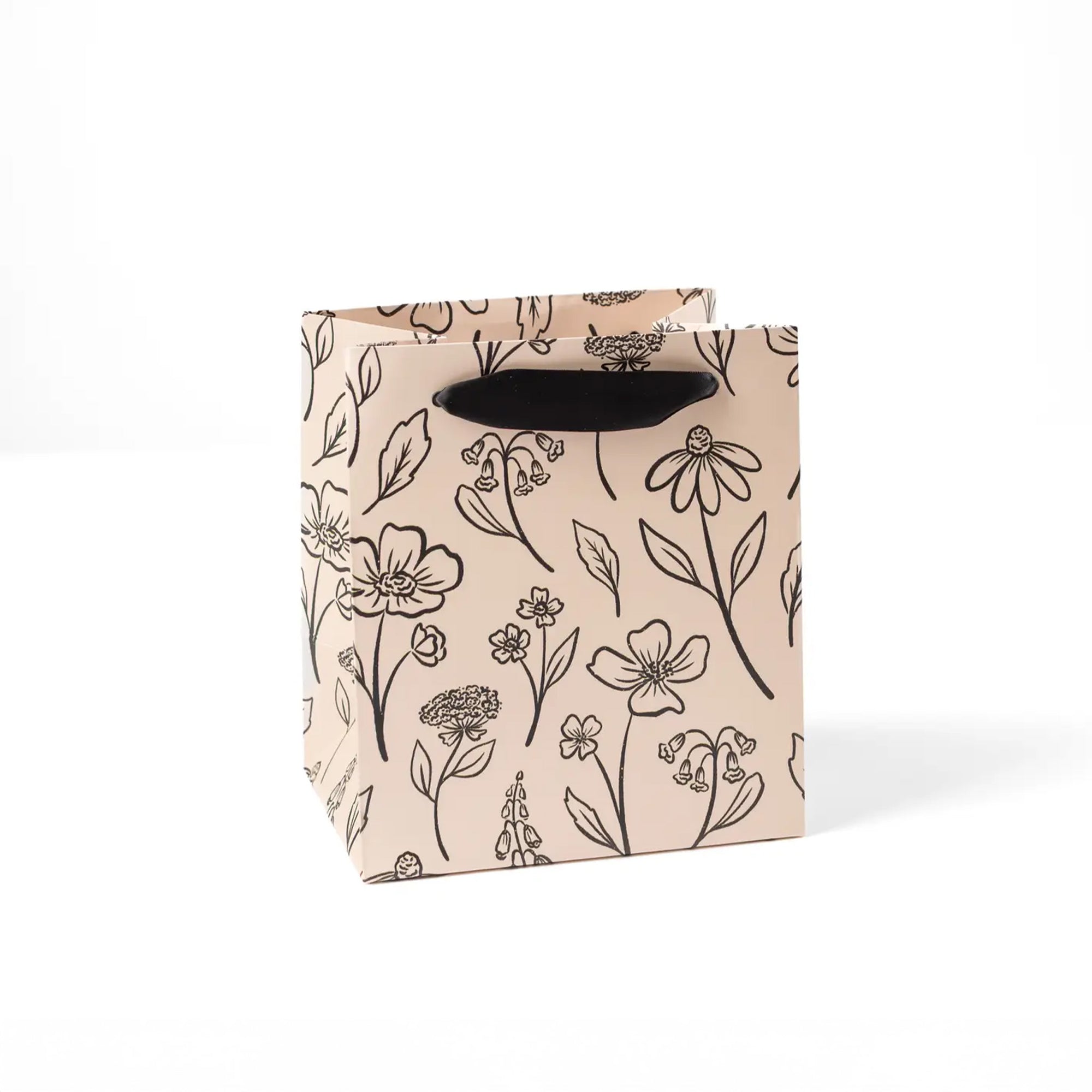 Tan small gift bag with black handle and sketched floral print