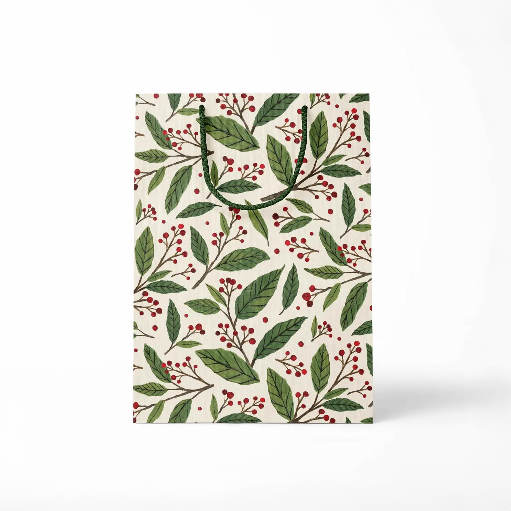 Gift bag with green leaf and red berry pattern on a white background