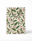 Gift bag with green leaf and red berry pattern on a white background