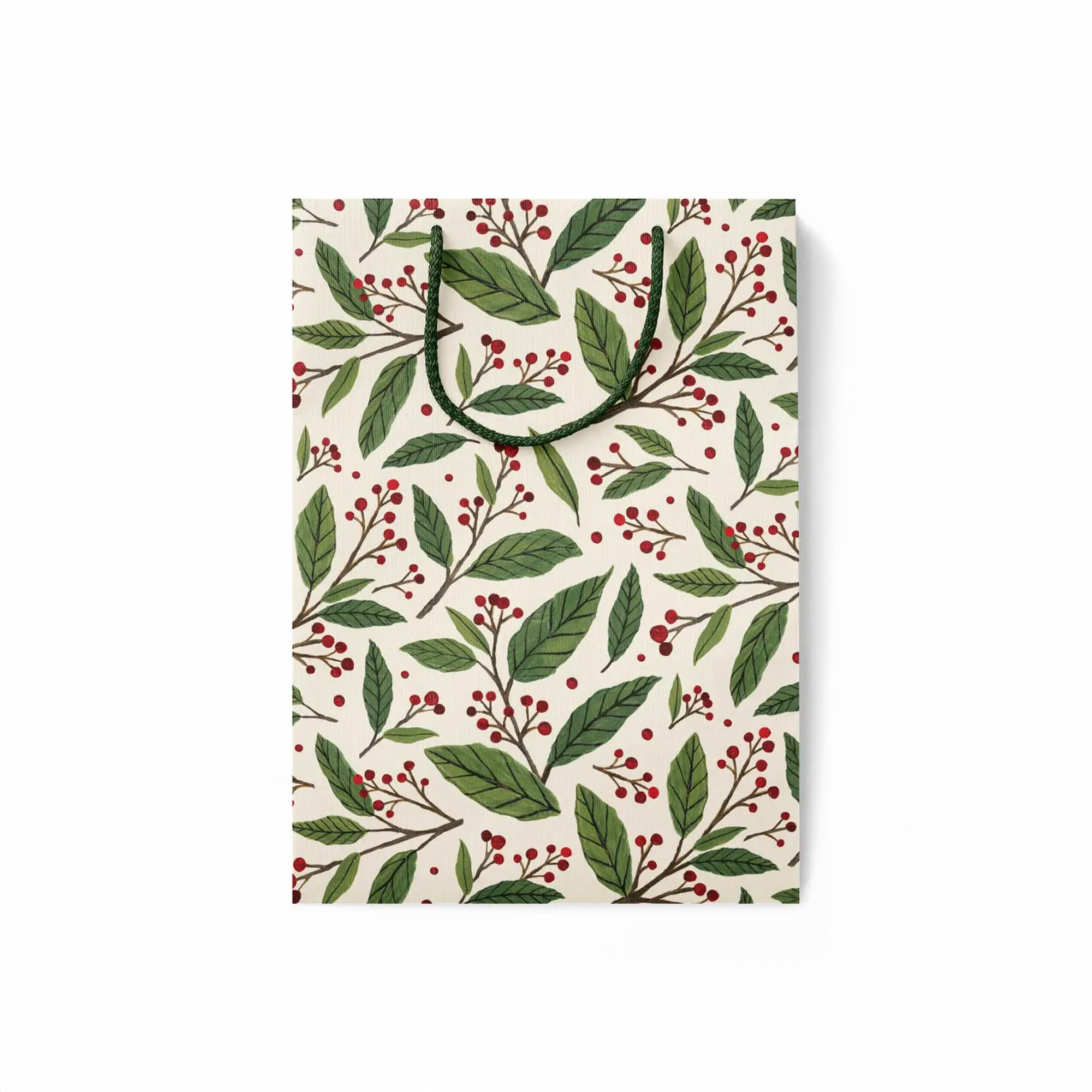 flattened gift bag with green leaf and red berry pattern on a white background