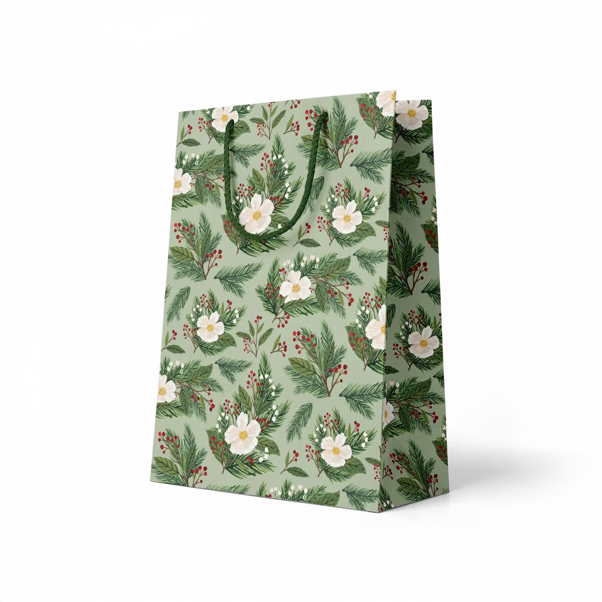 side view of green gift bag with white flowers and holly branches