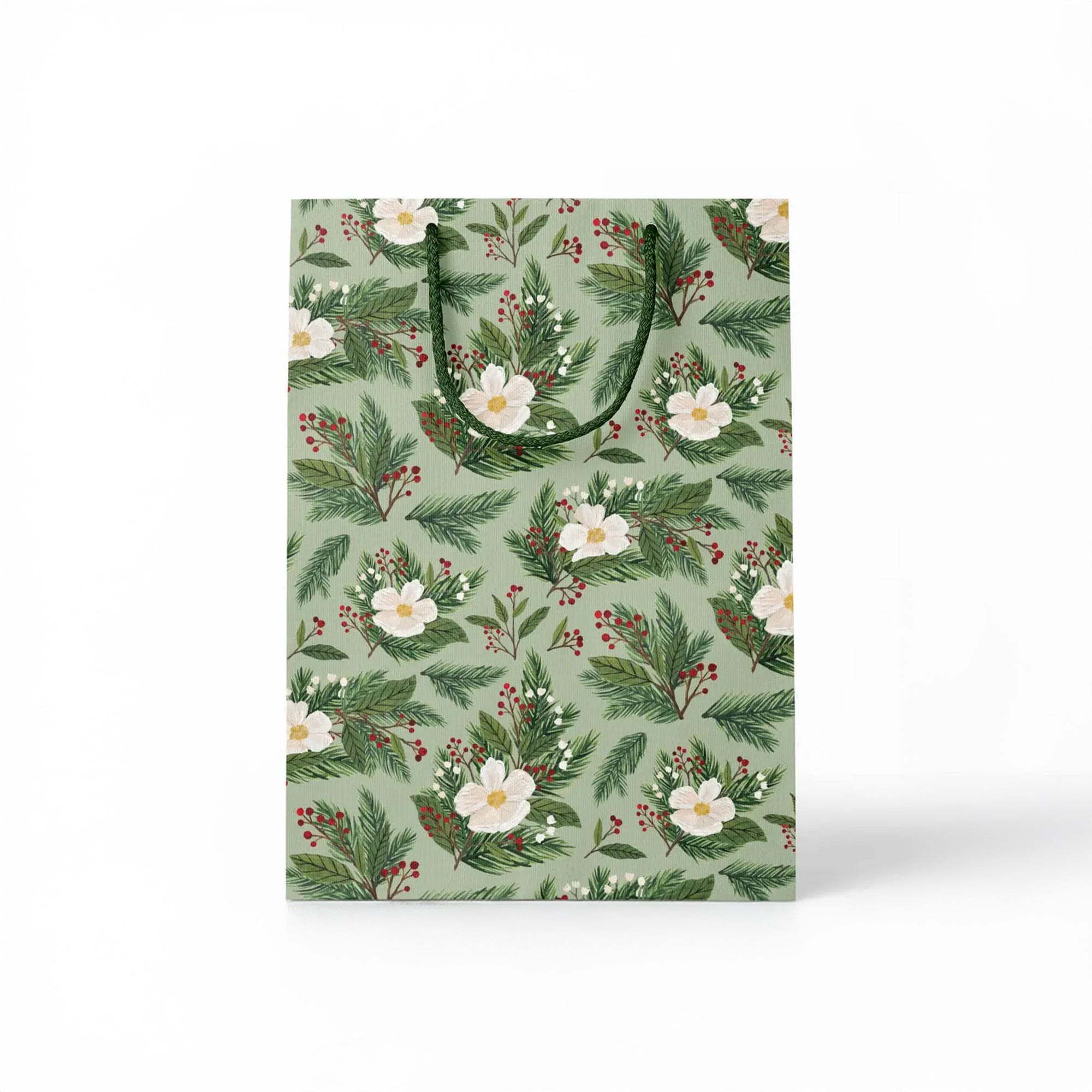 Green gift bag with white flowers and holly branches