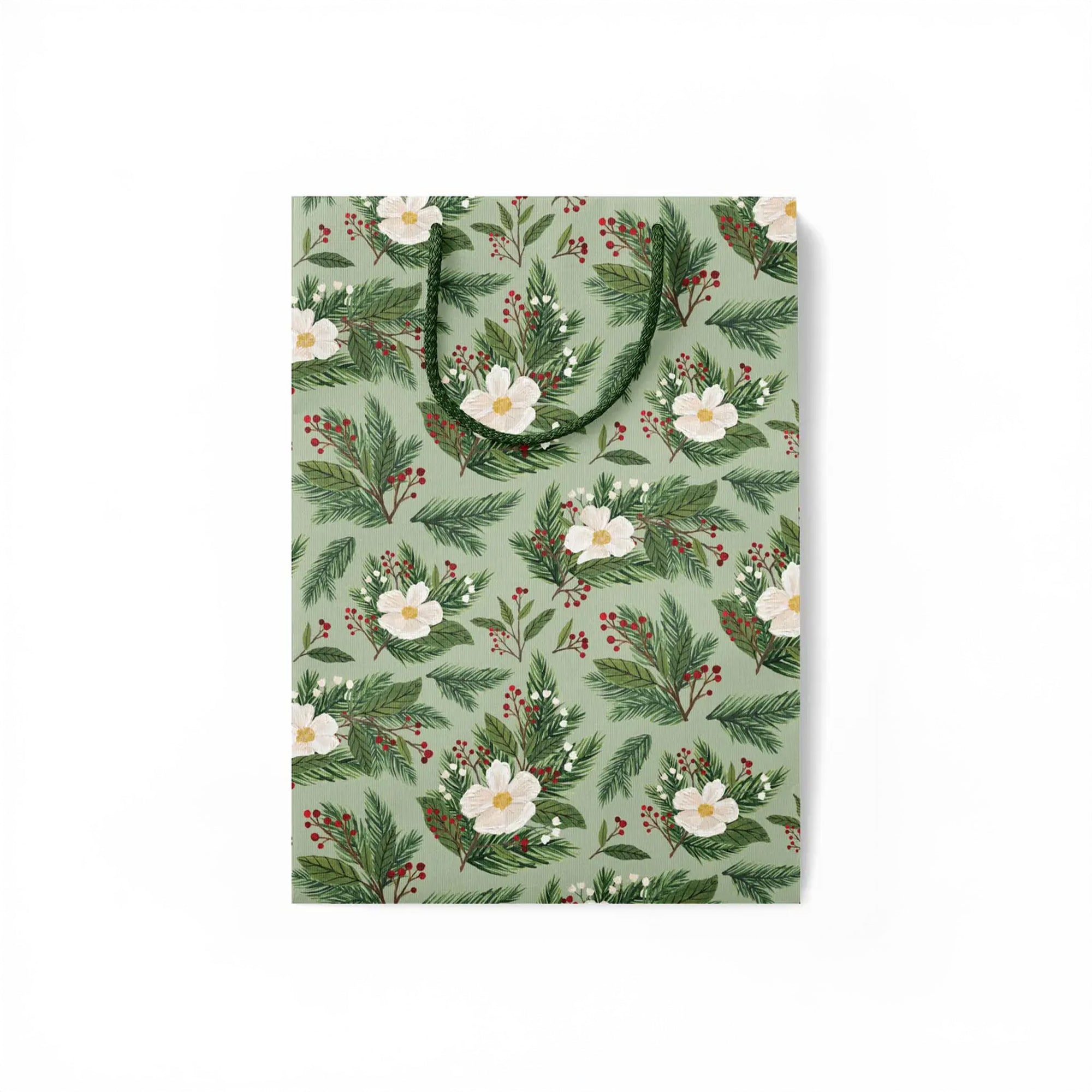 Flattened green gift bag with white flowers and holly branches