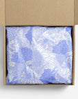 White and lavender floral tissue paper in a box