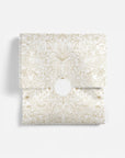 Decorative tissue paper with gold floral pattern on a white background