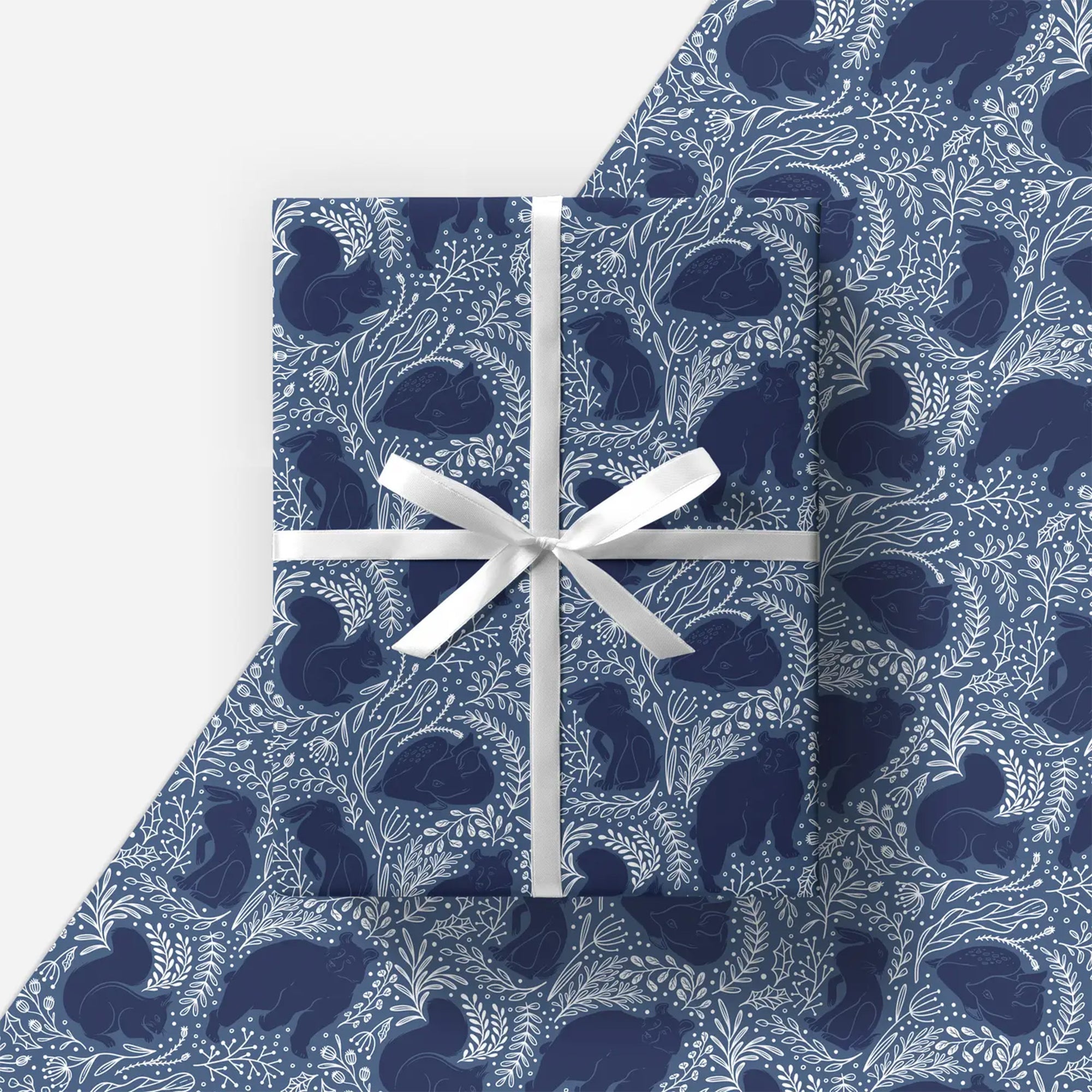 Blue patterned fabric with a white ribbon on a light gray background