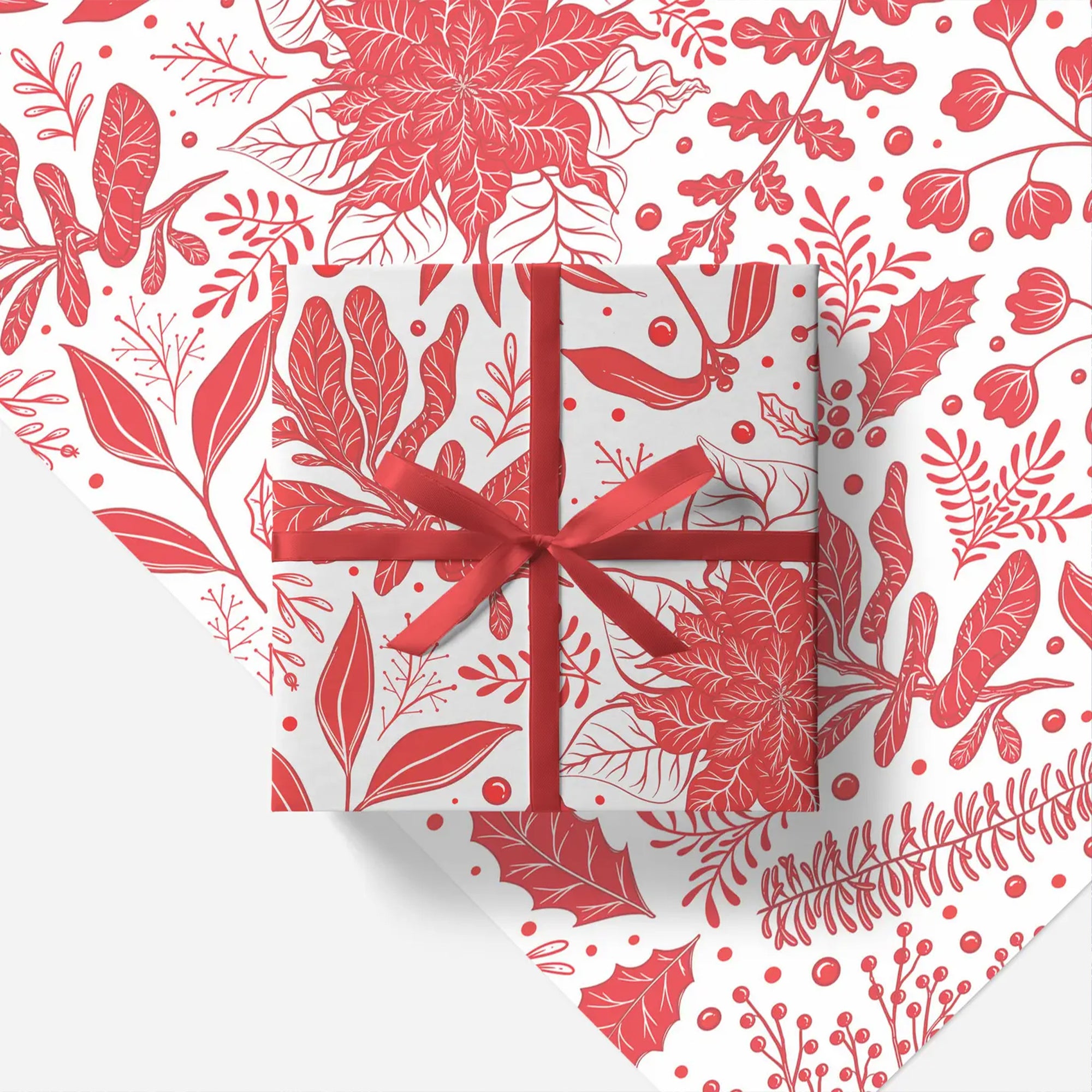 Gift box with red ribbon on a floral patterned paper
