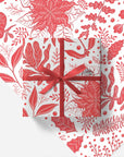 Gift box with red ribbon on a floral patterned paper