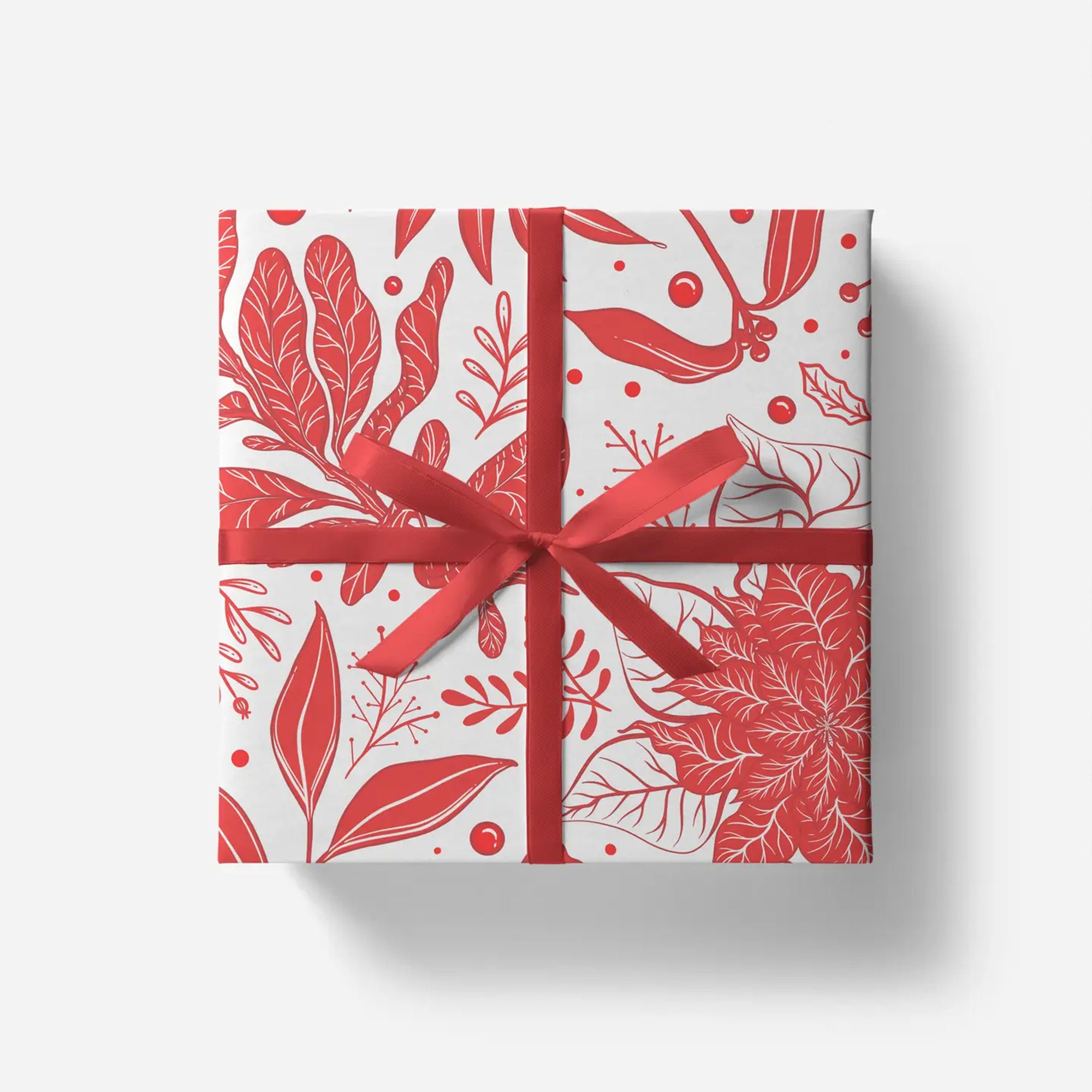 Gift box with red floral pattern and ribbon on a white background