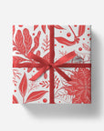 Gift box with red floral pattern and ribbon on a white background