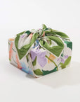 Rectangular box wrapped in colorful floral fabric on a white background
