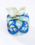 Patterned fabric bundle with a bow on a white background