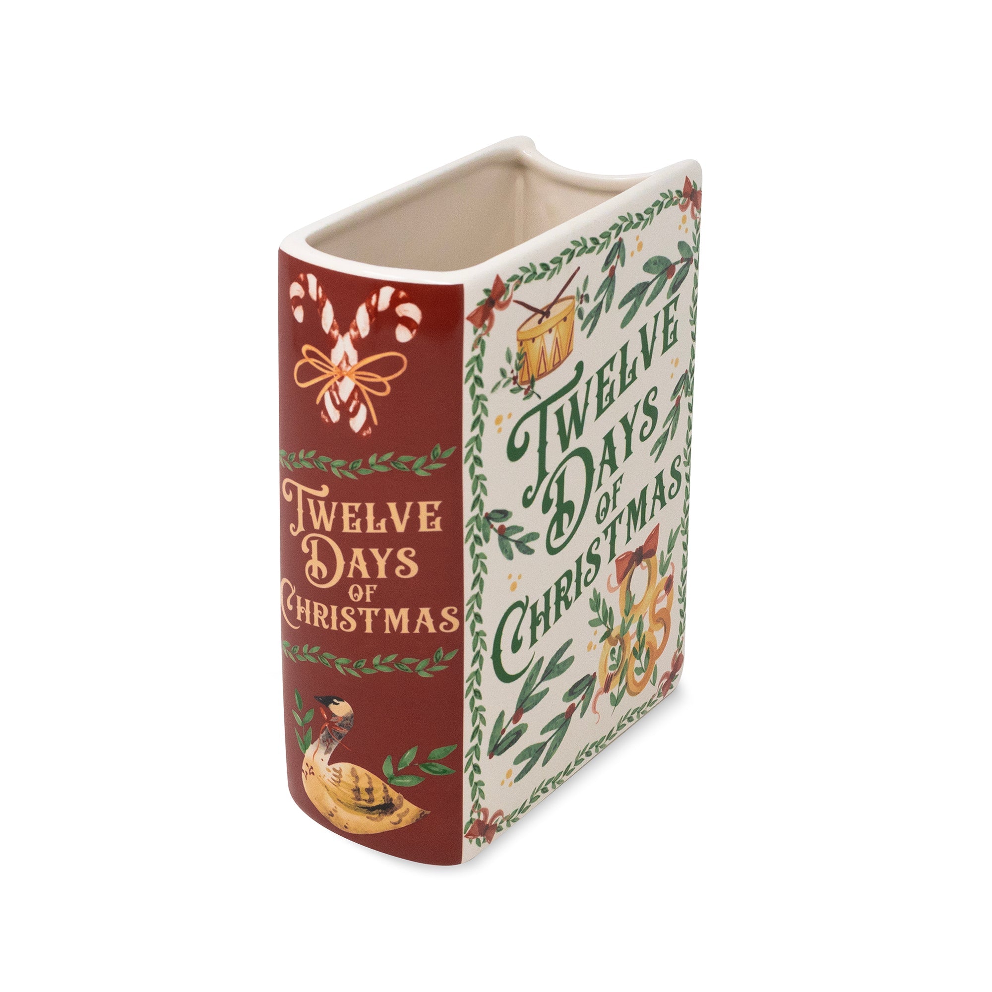 A ceramic Christmas ornament shaped like a book, featuring the text 'Twelve Days of Christmas' on a cream and green patterned cover with a dark red spine.