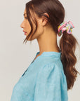 model wearing colorful hair scrunchie with pink trim