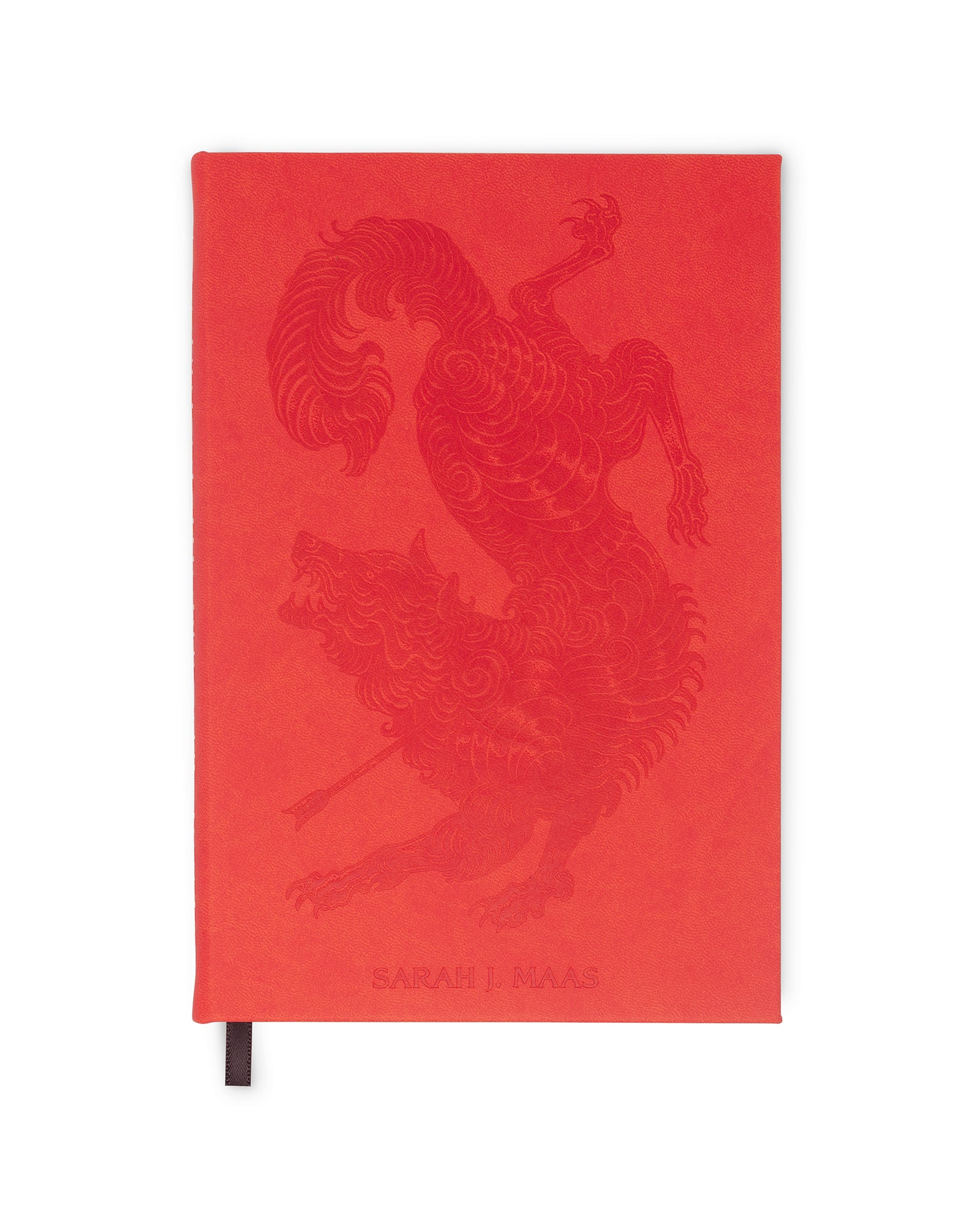Red notebook with a lion design on a white background
