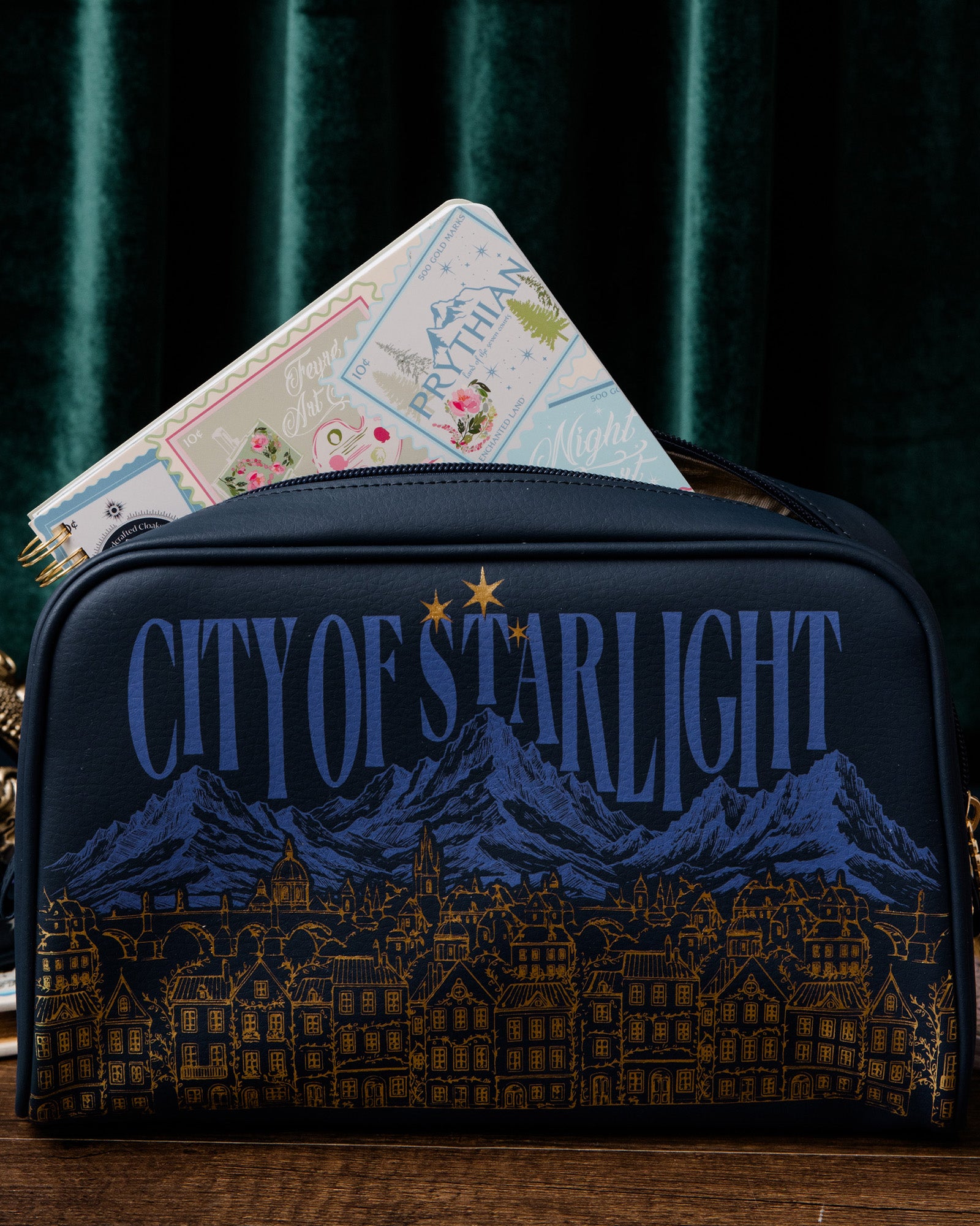 Navy blue bag with 'City of Starlight' design on a dark background