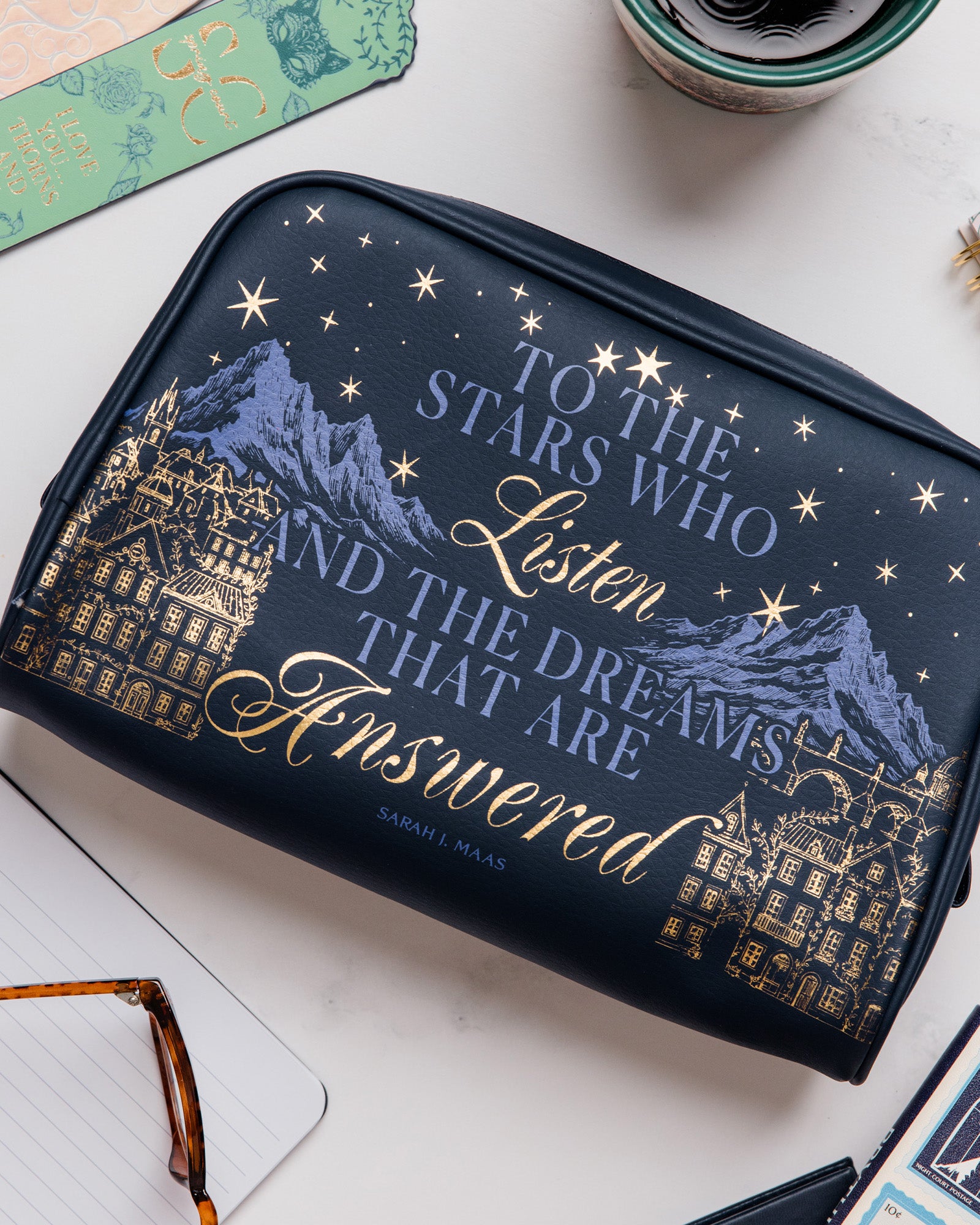 Navy blue pouch with mountain and star design, featuring text on a white background