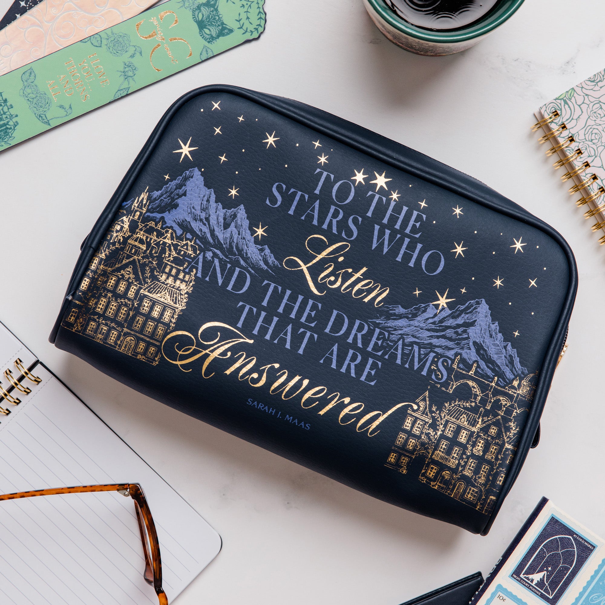 Navy blue pouch with mountain and star design, featuring text on a white background
