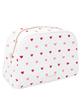 Side view of white cosmetic bag with pink and red heart pattern on a white background