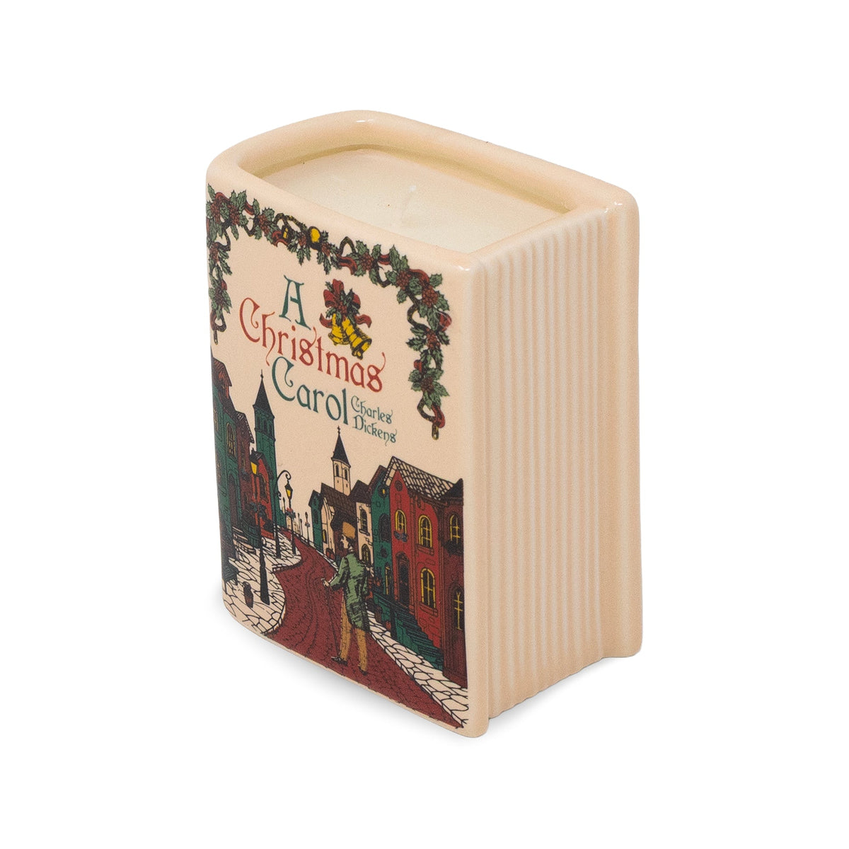A square ceramic Christmas candle with a cream-colored wax fill and a printed illustration of a snowy village street from 'A Christmas Carol' on the front, set against a plain white background.