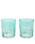 Two teal glass tumblers on a white background