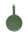 Green round luggage tag with 'kate spade New York' branding on a white background