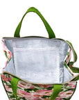 Floral-patterned cooler bag with green handles on a white background