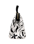 Sideview of white lunch bag with black floral pattern on a white background