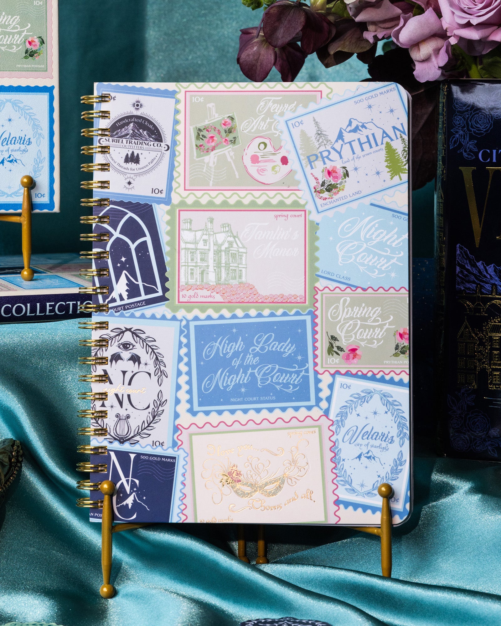 Notebook with decorative stamps on a silky teal background