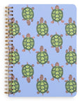 Notebook with green turtle pattern on a blue background