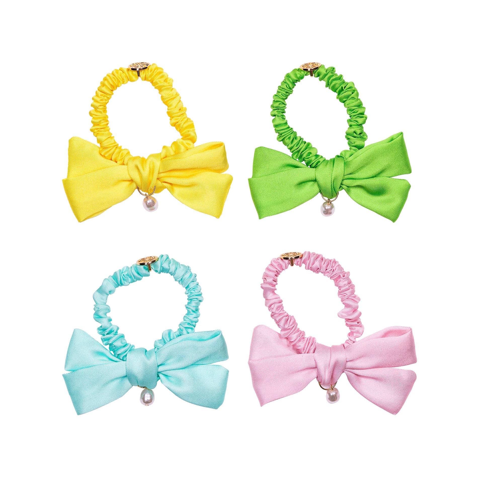 Four colorful hair bows with scrunchies on a white background