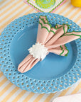 white sun napkin ring with a pink and green napkin inside