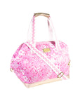 side view of pink and white floral print cooler bag with whit strap with ric rac detail and gold bottom